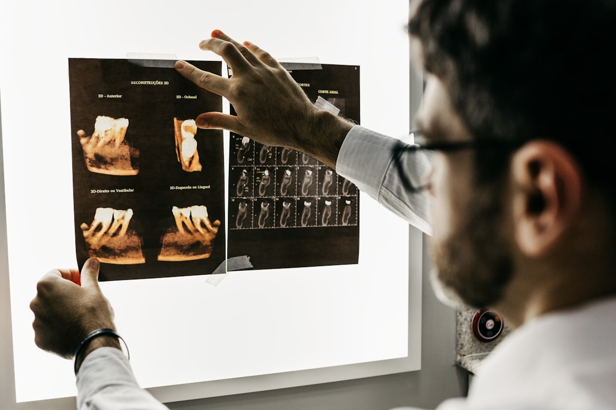 Dentist reviewing tooth X-rays to decide between a root canal and an extraction at Clarenville Dental Care